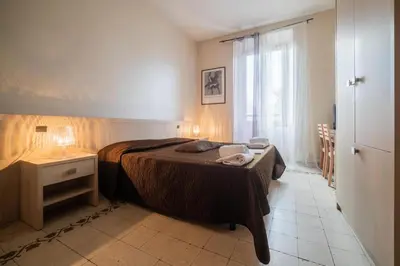 a bedroom with a bed and a table and a window at Reyes Suite & Rooms in Rome