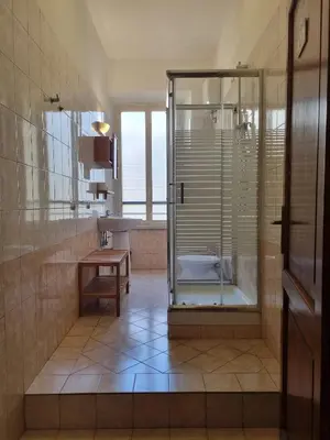 a bathroom with a shower and a sink at Reyes Suite & Rooms in Rome