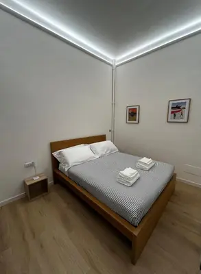 a bedroom with a bed with two towels on it at flaTminio modern & nice apartment in Rome