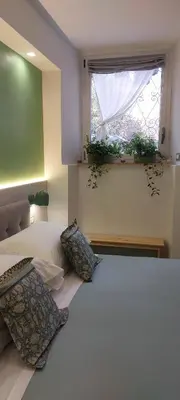 a bedroom with a bed with two pillows and a window at The Golden Pyramid in Rome