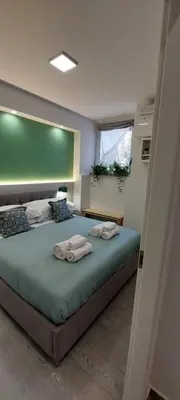 a bedroom with a large bed with towels on it at The Golden Pyramid in Rome