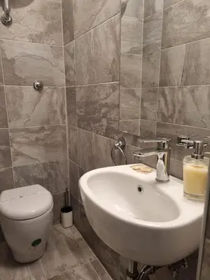 a bathroom with a white sink and a toilet at Happy Home Piramide Cestia Lussuoso Unico Esclusivo a Roma in Rome