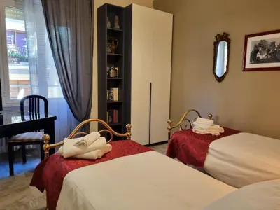 a bedroom with two beds and a book shelf at Happy Home Piramide Cestia Lussuoso Unico Esclusivo a Roma in Rome