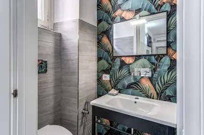 a bathroom with a sink and a mirror at AltaDomus Roma in Rome