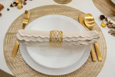 a white plate with a gold napkin on a table at Colosseo Romantic Suite in Rome