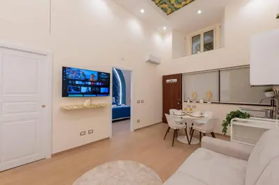a living room with a couch and a table at Colosseo Romantic Suite in Rome