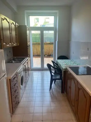 a kitchen with a sink and a table and a stove at Apartment V12 in Rome