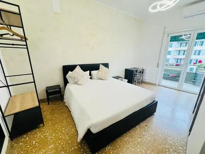 a bedroom with a white bed and a ladder at Valentina House in Rome