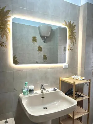 a bathroom with a sink and a mirror at Valentina House in Rome