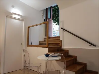 a room with a table and a staircase with a window at viaCatania16 in Rome