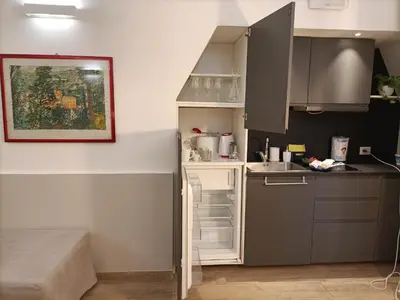 a small kitchen with a sink and a refrigerator at viaCatania16 in Rome