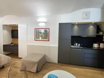 a living room with a kitchen and a table at viaCatania16 in Rome
