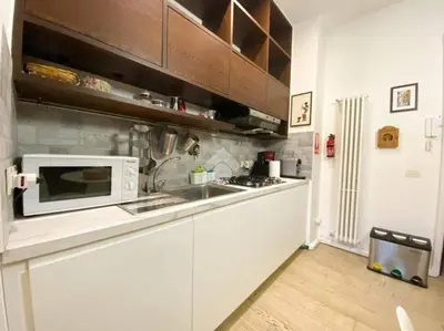 a kitchen with a sink and a microwave at Trastevere Charme in Rome
