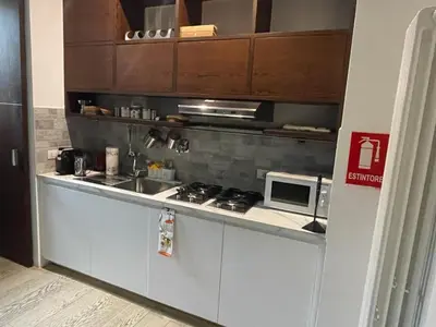 a small kitchen with a stove and a microwave at Trastevere Charme in Rome