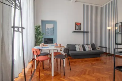 a living room with a table and chairs and a couch at Ezio House in Rome