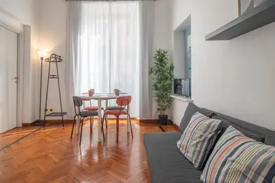 a living room with a table and chairs at Ezio House in Rome