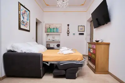 a bedroom with a bed and a television in it at MAJOR DOMUS 501 in Rome