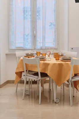 a dining room table with a yellow table cloth on it at MAJOR DOMUS 501 in Rome