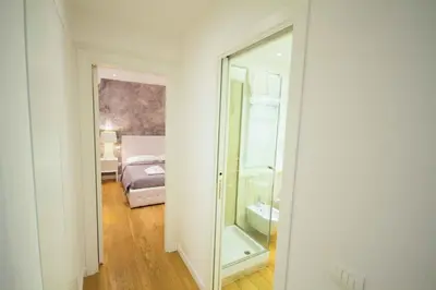 a bathroom with a mirror and a bedroom with a bed at Apartment Via del Corso in Rome