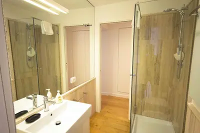 a bathroom with a sink and a glass shower at Apartment Via del Corso in Rome