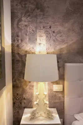 a white lamp sitting on a table in a bedroom at Apartment Via del Corso in Rome