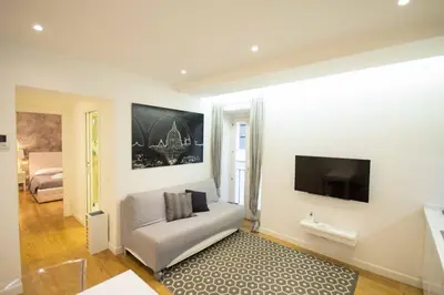 a living room with a couch and a flat screen tv at Apartment Via del Corso in Rome