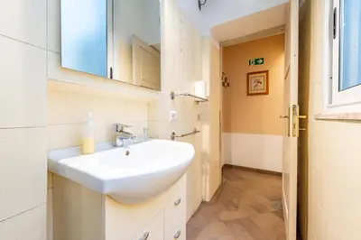a bedroom with a bed and a desk and a table at 3 House - by Ghor in Rome