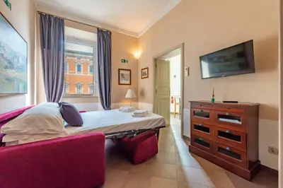 a living room with a red couch and a dresser at 3 House - by Ghor in Rome