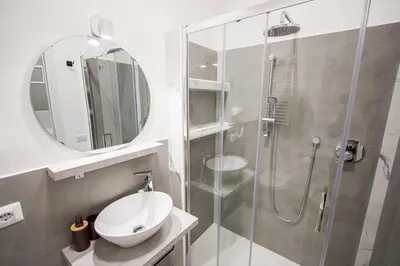 a bathroom with a shower and a sink and a mirror at ODESCALCHI LOFT in Rome