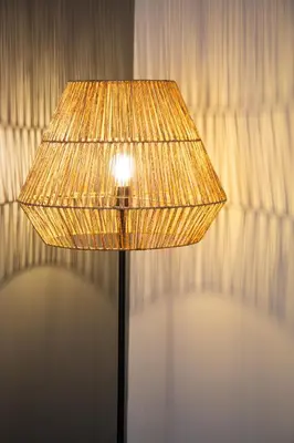 a lamp with a shade in front of a curtain at Bright apartment near San Pietro in Rome