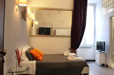 a bedroom with a bed with a mirror on the wall at Vatican Santamaura 39 in Rome