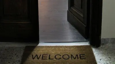 a welcome mat on the floor in front of a door at Vatican Santamaura 39 in Rome