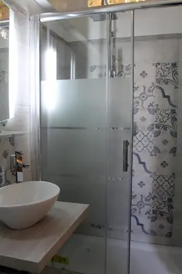 a bathroom with a sink and a glass shower at Vatican Santamaura 39 in Rome