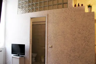 a room with a door leading to a bathroom at Vatican Santamaura 39 in Rome