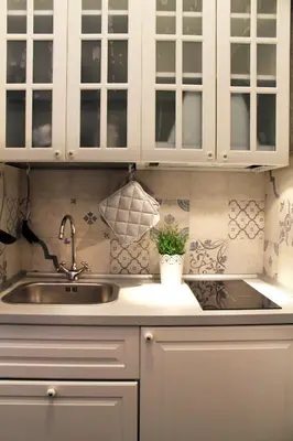 a kitchen with white cabinets and a sink at Vatican Santamaura 39 in Rome