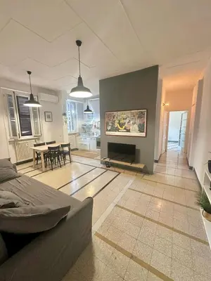 a living room with a fireplace and a dining room at Maison San Lorenzo Roma in Rome