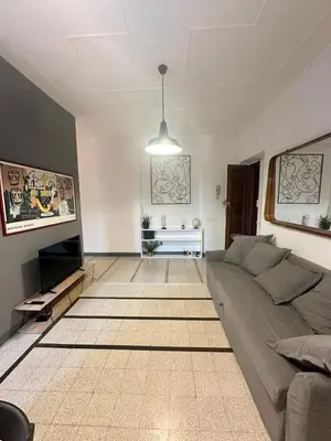 a living room with a couch and a television at Maison San Lorenzo Roma in Rome