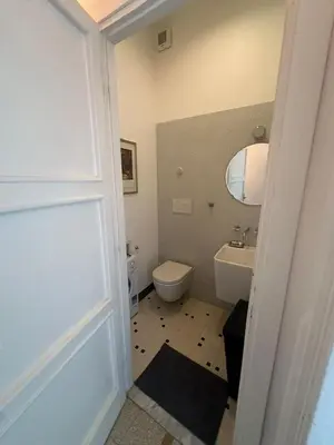 a bathroom with a white toilet and a sink at Maison San Lorenzo Roma in Rome