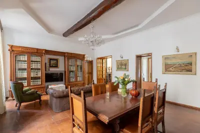 a dining room with a wooden table and chairs at iFlat Elegant 3 bedroom apt near the Pantheon in Rome