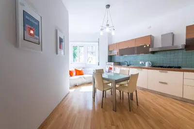 a kitchen and dining room with a table and chairs at Leoncavallo Retreat in Rome