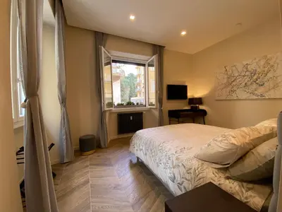 a bedroom with a bed and a window at Ghirlanda House in Rome