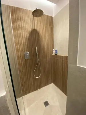 a bathroom with a shower with a shower head at Ghirlanda House in Rome