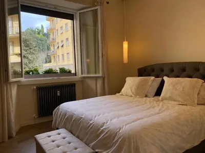 a bedroom with a large bed and a window at Ghirlanda House in Rome