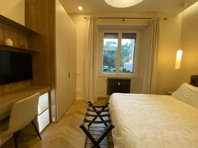 a hotel room with a bed and a window at Ghirlanda House in Rome