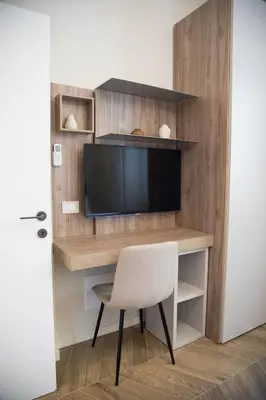 a desk with a television and a chair in a room at Ghirlanda House in Rome