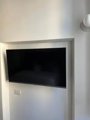a flat screen tv hanging on a wall at Maison Romana Trastevere Suites in Rome