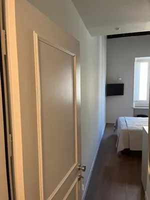 a sliding door in a bedroom with a bed at Maison Romana Trastevere Suites in Rome