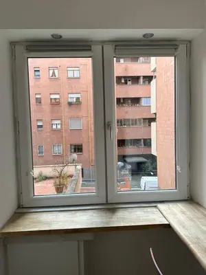 a window in a room with a wooden window sill at Aurelius Holiday Home in Rome