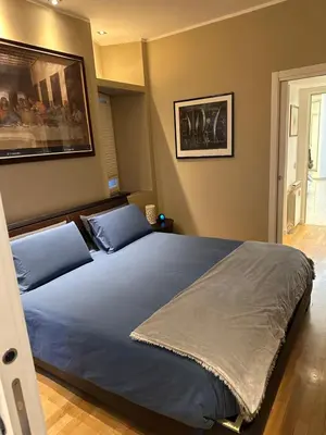 a bedroom with a bed with two blue pillows at Aurelius Holiday Home in Rome