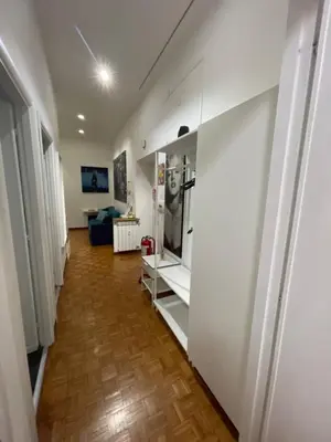 a hallway with a room with a refrigerator in it at Nova Domus Colosseo in Rome